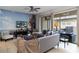Relaxing living room with entertainment center and sliding glass doors to the outdoor patio at 1995 Majorca Dr, Kissimmee, FL 34747