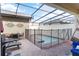Screened-in pool area features ample patio space and outdoor seating for entertaining at 1995 Majorca Dr, Kissimmee, FL 34747