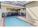 Inviting outdoor pool area with seating, grilling station, and covered patio for relaxation at 1995 Majorca Dr, Kissimmee, FL 34747