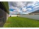 Lush backyard enclosed with a white fence and green grass, perfect for outdoor activities at 2059 Dexter St, Haines City, FL 33844