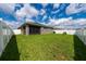 Expansive fenced backyard showcasing a well-maintained lawn and the home's rear exterior at 2059 Dexter St, Haines City, FL 33844