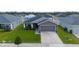 Aerial view of single-story home with well-kept lawn in a residential community with similar homes at 2059 Dexter St, Haines City, FL 33844