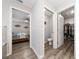 Hallway view into bedroom, water closet, and walk-in closet with wood look flooring at 2059 Dexter St, Haines City, FL 33844