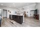 Open kitchen flows into living area, features island with seating, and stainless appliances at 2059 Dexter St, Haines City, FL 33844