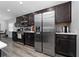Kitchen with stainless steel appliances, dark wood cabinets, and gray tile backsplash at 2059 Dexter St, Haines City, FL 33844