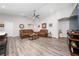 Spacious living room with modern gray flooring, neutral walls, and updated ceiling fan at 2059 Dexter St, Haines City, FL 33844