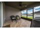 Covered outdoor patio featuring neutral earth tone colors with seating and ceiling fan at 2059 Dexter St, Haines City, FL 33844