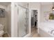 Bathroom with glass-enclosed shower, toilet, and soaking tub with tiled surround at 2735 Lido Key Dr, Kissimmee, FL 34747