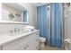 Bright bathroom featuring a white vanity, an LED mirror, and a blue patterned shower curtain at 2735 Lido Key Dr, Kissimmee, FL 34747