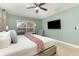Serene bedroom with a ceiling fan, plush bedding, and a mounted television at 2735 Lido Key Dr, Kissimmee, FL 34747