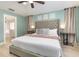 Cozy bedroom featuring a tufted headboard, ceiling fan, and neutral color palette at 2735 Lido Key Dr, Kissimmee, FL 34747