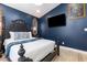 Stylish bedroom featuring a luxurious dark-framed bed, decorative mirrors, and a wall-mounted TV at 2735 Lido Key Dr, Kissimmee, FL 34747