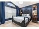Elegantly decorated bedroom with an ornate, dark-framed bed, complementary mirrors and lighting at 2735 Lido Key Dr, Kissimmee, FL 34747