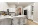 Stylish kitchen featuring white cabinetry, quartz countertops and seating at the breakfast bar at 2735 Lido Key Dr, Kissimmee, FL 34747