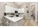 Bright kitchen featuring white cabinets, stainless steel appliances, and a quartz countertop island at 2735 Lido Key Dr, Kissimmee, FL 34747