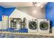Convenient laundry room setup featuring modern washer and dryer on colorful rubber flooring at 2735 Lido Key Dr, Kissimmee, FL 34747