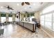 Relaxing lounge area with ceiling fans, tables, chairs, and a bar with white brick accents at 2735 Lido Key Dr, Kissimmee, FL 34747