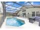 Inviting screened-in pool area with clear blue water, an adjacent spa, and outdoor seating at 2735 Lido Key Dr, Kissimmee, FL 34747