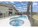Enclosed backyard pool and hot tub offer leisure and relaxation with a lounging area and safety fence at 2735 Lido Key Dr, Kissimmee, FL 34747