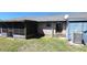 Fenced backyard with grass, patio, and brick house exterior at 2781 King Oak Cir, St Cloud, FL 34769