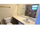 Neutral bathroom featuring a vanity, toilet and shower with tiled walls, with a large mirror at 2781 King Oak Cir, St Cloud, FL 34769
