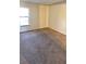Vacant room featuring neutral walls and carpeting, offering a simple and clean aesthetic at 2781 King Oak Cir, St Cloud, FL 34769