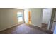 Neutral bedroom with carpet flooring, a window for natural light, and access to a bathroom and closet at 2781 King Oak Cir, St Cloud, FL 34769