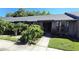 Inviting brick facade with a well-maintained lawn, lush plants, and a clear walkway to the front door at 2781 King Oak Cir, St Cloud, FL 34769