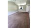 Spacious living room with neutral walls, carpet flooring, and an open view to the kitchen at 2781 King Oak Cir, St Cloud, FL 34769