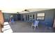 A neutral covered patio space, with a variety of seating and ceiling fans at 2781 King Oak Cir, St Cloud, FL 34769