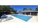 A beautiful community pool with comfortable seating and lush trees at 2781 King Oak Cir, St Cloud, FL 34769