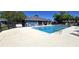 A beautiful community pool with comfortable seating and lush trees at 2781 King Oak Cir, St Cloud, FL 34769