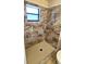 Tiled shower featuring decorative tile accents, a showerhead, and a window for natural light at 2781 King Oak Cir, St Cloud, FL 34769