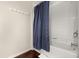 Bright bathroom featuring a blue shower curtain over a bathtub at 2903 Edenshire Way # 103, Kissimmee, FL 34746