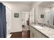 Well-lit bathroom featuring a single vanity with granite countertop and view into the bedroom at 2903 Edenshire Way # 103, Kissimmee, FL 34746