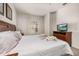 Inviting bedroom with soft lighting, floral bedspread, and TV at 2903 Edenshire Way # 103, Kissimmee, FL 34746