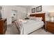 Spacious bedroom featuring a large bed, art prints, and ensuite bathroom at 2903 Edenshire Way # 103, Kissimmee, FL 34746