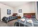 Bright bedroom featuring two beds, framed artwork and soft lighting from a bedside lamp at 2903 Edenshire Way # 103, Kissimmee, FL 34746