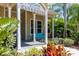 Covered entry to the Lucaya Village Clubhouse with lush landscaping at 2903 Edenshire Way # 103, Kissimmee, FL 34746