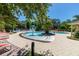 Community pool area with a water fountain, lounge seating, and jacuzzi at 2903 Edenshire Way # 103, Kissimmee, FL 34746