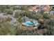 Aerial view of community pool with lounge seating and a jacuzzi at 2903 Edenshire Way # 103, Kissimmee, FL 34746