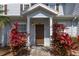Townhouse front door with inviting covered entrance and landscaping at 2903 Edenshire Way # 103, Kissimmee, FL 34746