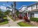 Inviting townhouse row with sidewalk and tropical landscaping in front at 2903 Edenshire Way # 103, Kissimmee, FL 34746