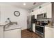 Bright kitchen featuring granite countertops, stainless steel appliances, and ample cabinet space at 2903 Edenshire Way # 103, Kissimmee, FL 34746