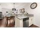 Open concept kitchen with stainless steel dishwasher, sink and stylish dining area at 2903 Edenshire Way # 103, Kissimmee, FL 34746