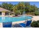 Community pool with lounge chairs, sun and shade, a water feature, and blue water at 2903 Edenshire Way # 103, Kissimmee, FL 34746