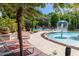 Community pool with lounge chairs, shade, water feature, and landscaped walkway at 2903 Edenshire Way # 103, Kissimmee, FL 34746