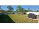 Spacious backyard featuring a well-maintained lawn, privacy fence, patio area, and outdoor seating at 2950 Scarlett Dr, St Cloud, FL 34772