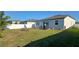 Spacious backyard with a well-maintained lawn, patio area, privacy fence and outdoor seating at 2950 Scarlett Dr, St Cloud, FL 34772
