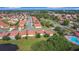 A high up aerial view of the community, showing landscaping, homes and neighborhood streets at 3105 Sangria St, Kissimmee, FL 34744